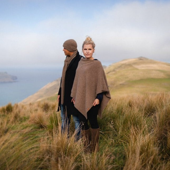 Woman wearing a brown wool poncho.