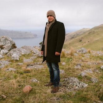 Man wearing natural brown woolen scarf from Wyld.