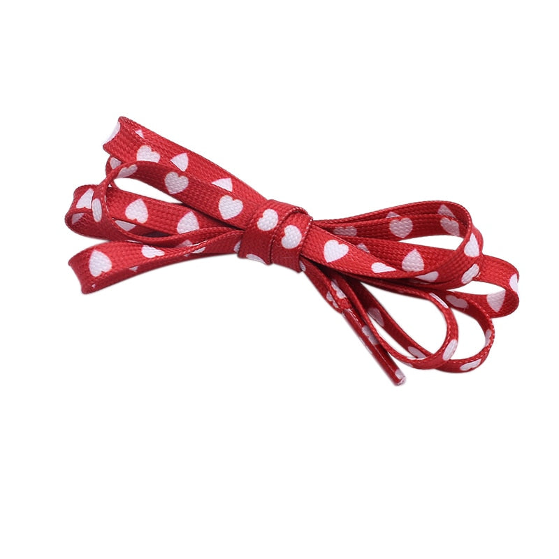 Red shoelaces with white hearts.