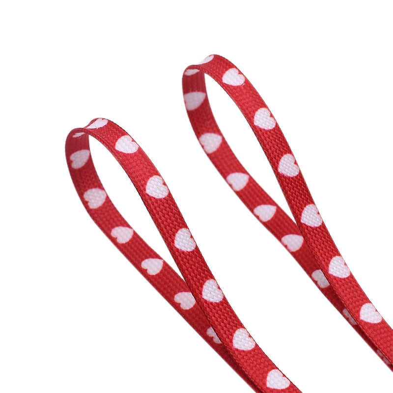 Red shoelaces with white hearts.