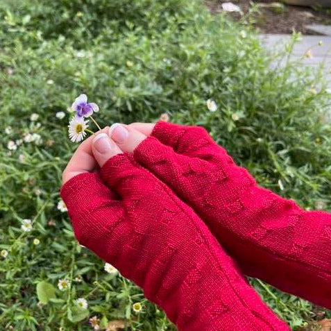 Fingerless merino gloves in red textured knit.