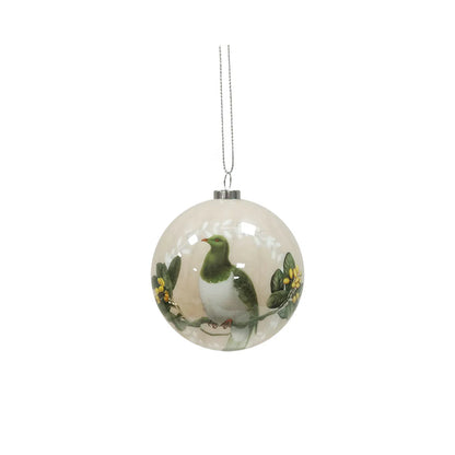 Cream coloured Christmas bauble featuring a Kereru bird on a Puriri tree branch.