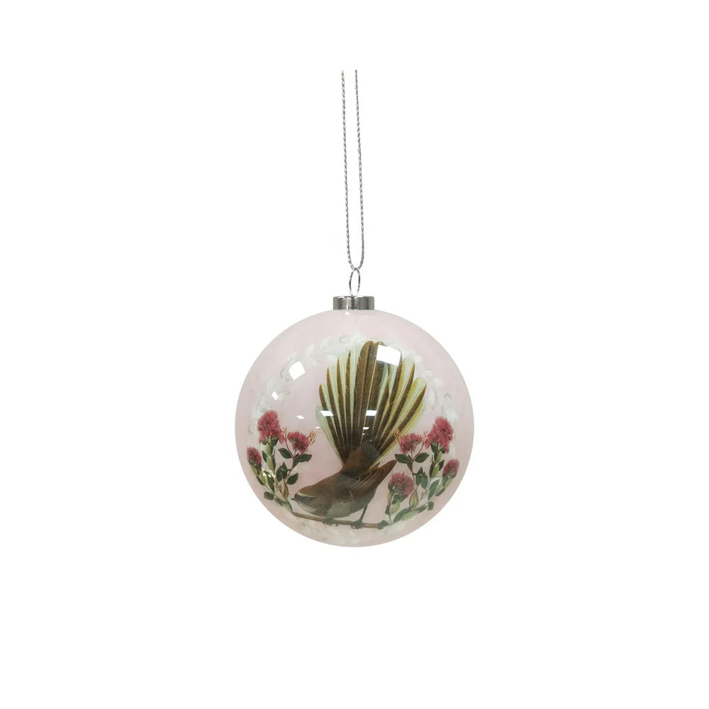 Pale pink Christmas bauble featuring a Fantail bird and Pohutukawa flowers.