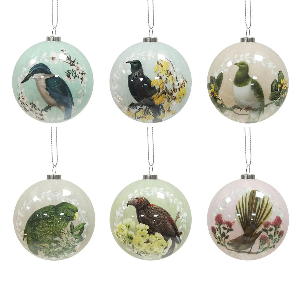 Six round Christmas baubles each in a light pastel colour. Each bauble features a native NZ bird perched on a native NZ flower.