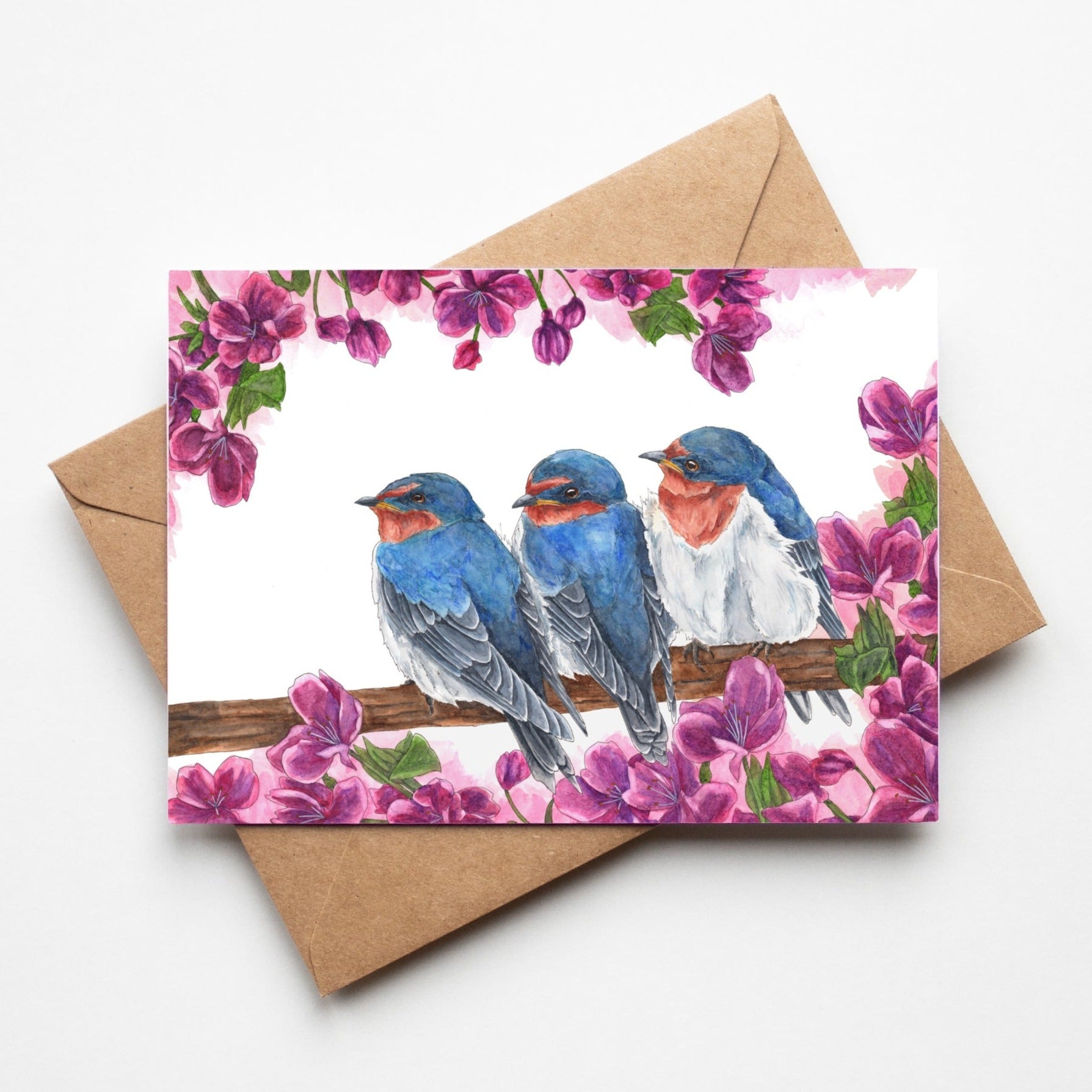 Greeting card by artist Leah Ingram featuring 3 Swallows on a branch surrounded by purple flowers.