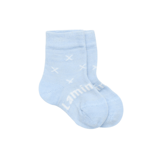 Baby crew socks in pale blue knit merino wool with a white X pattern.