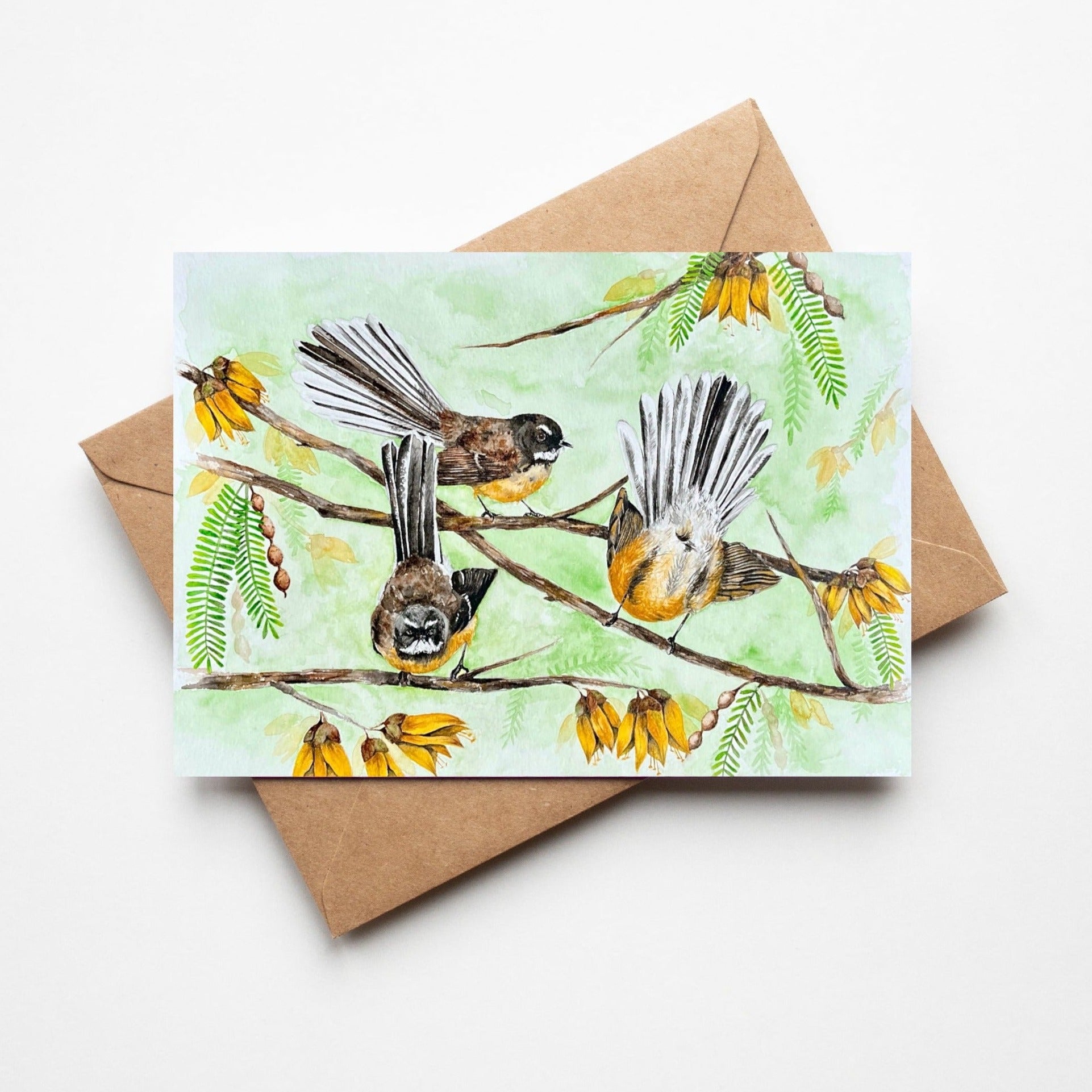 Greeting card by artist Leah Ingram featuring Fantails birds amongst Kowhai flowers.