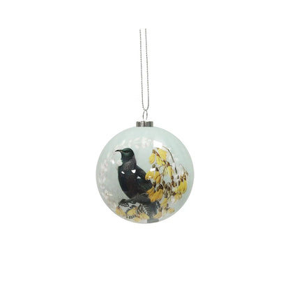 Pale green Christmas bauble featuring a Tui bird with Kowhai flowers.