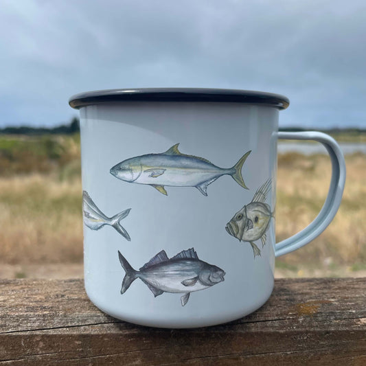 Enamel mug in pale blue with fish decals on it.
