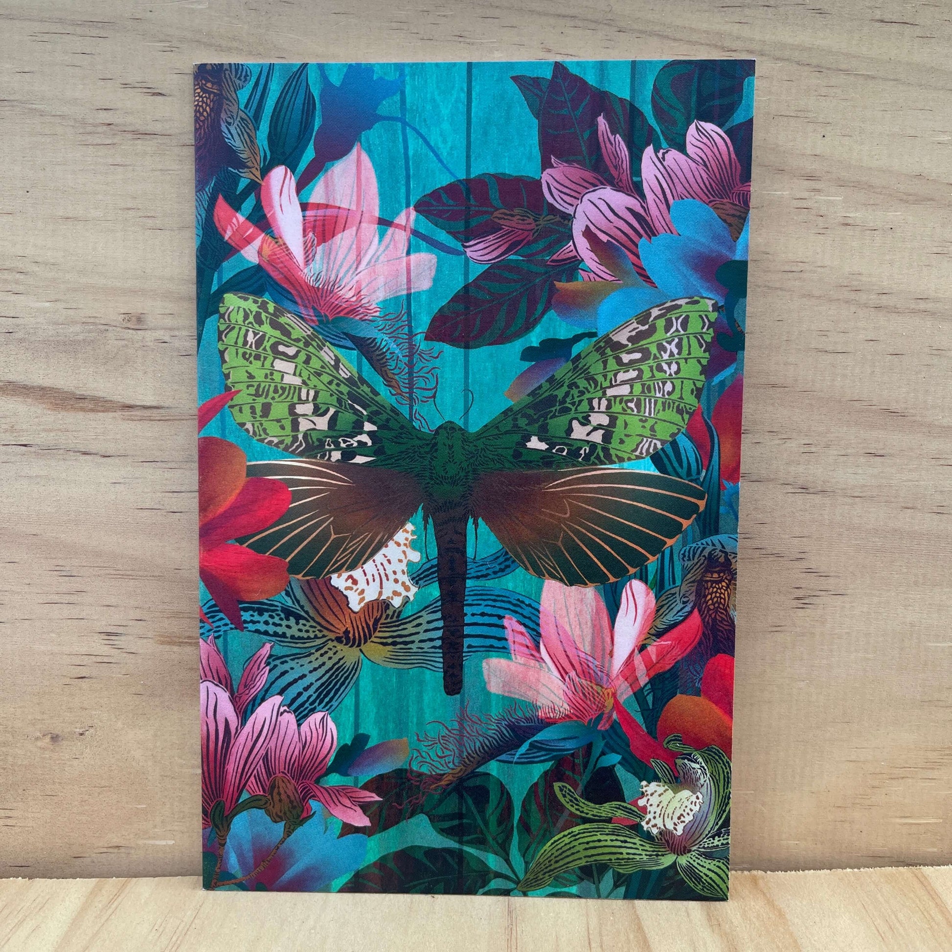 Greeting card designed by artist Flox featuring a moth and magnolia flowers in bold colours.
