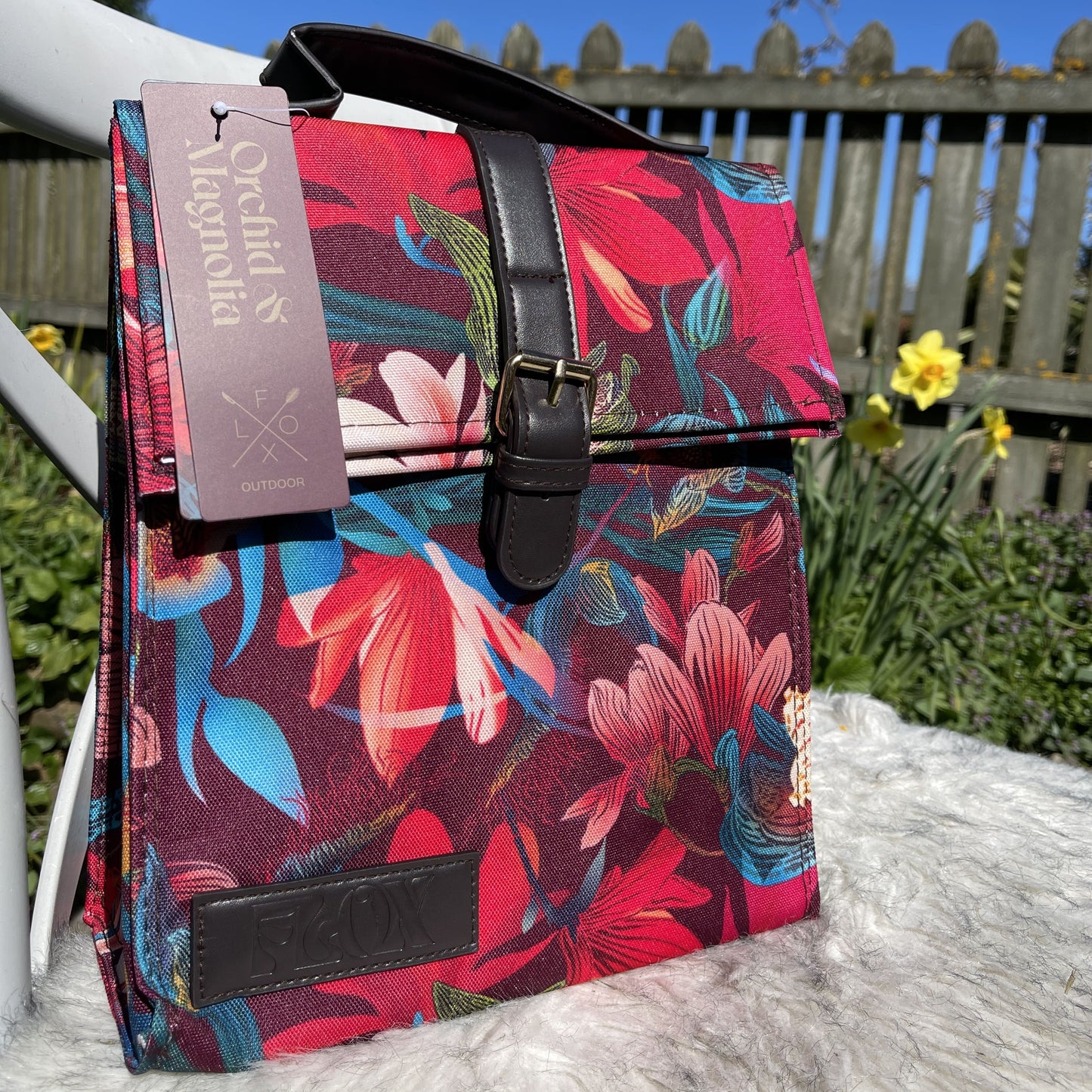 Colourful flox designed small lunch bag in dark burgundy with bright magnolia flower print.
