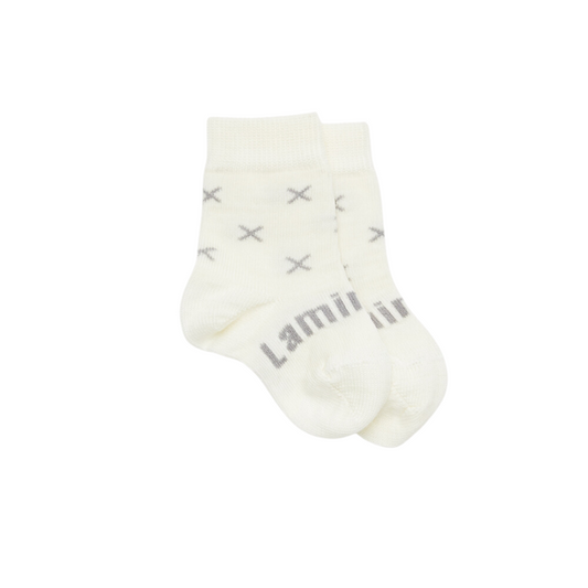 Baby crew socks in pretty cream knit merino wool with a grey X pattern.