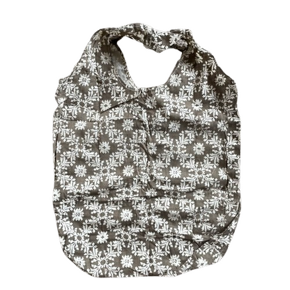 Taupe cotton tote bag with white floral decorative pattern.