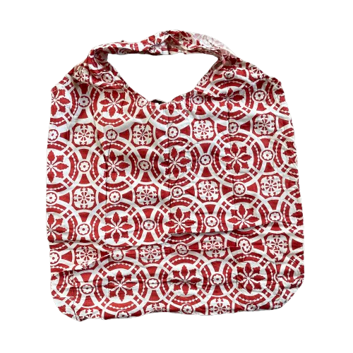 Red cotton tote bag with white floral decorative pattern.