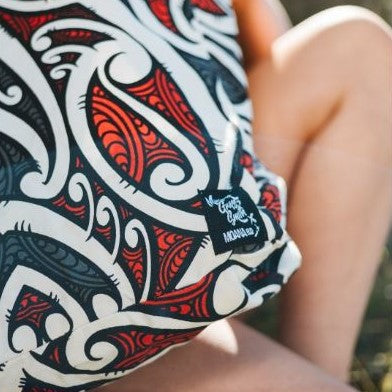 Tote bag with red, black and white maori design.
