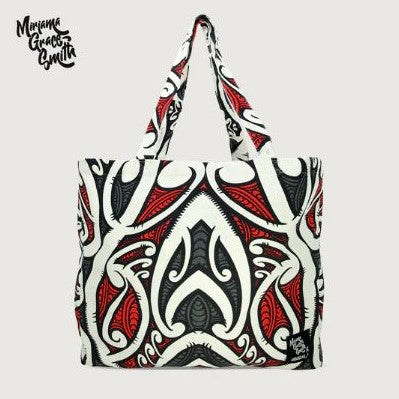 Tote bag with red, black and white maori design.