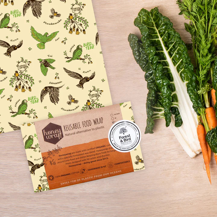Honeywrap reusable food wrap made from organic cotton and a bees wax blend. Used to wrap over foods instead of using single use plastic. With spinach and carrots on the side