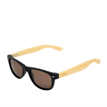 Black-framed sunglasses with light natural wood temples and brown tinted lenses, shown on a plain white background.