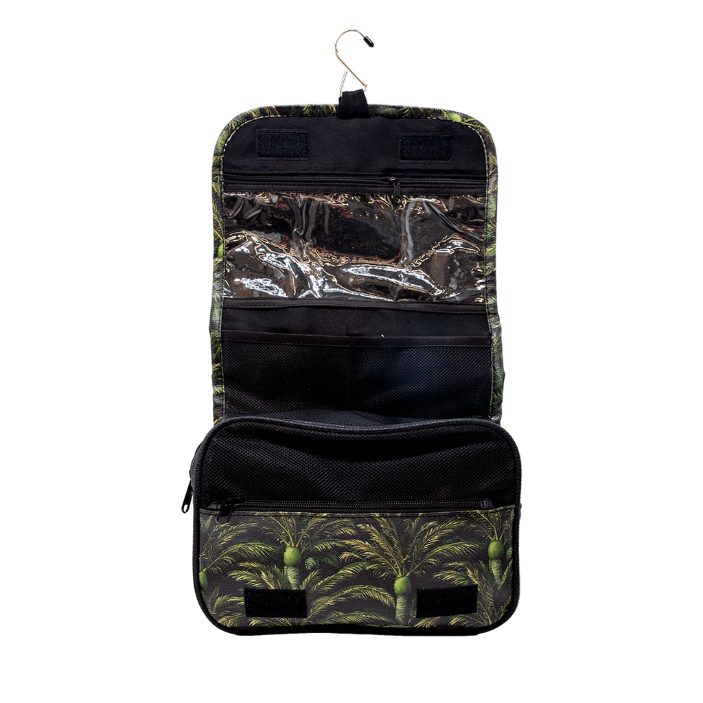 A hanging toiletry bag with a green and black palm tree pattern, featuring a top hanger, clear plastic organizer pockets, and a zippered compartment, shown against a plain white background.