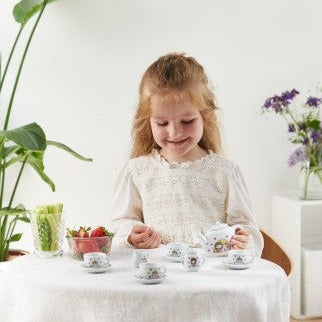 Child playing with a teaset.