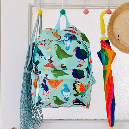 Back of a minty green backpack covered in bright prints of New Zealand birds.