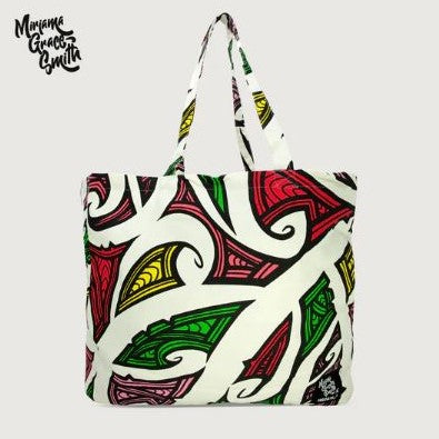 Tote bag with red, pink, green, yellow, white & black maori design.