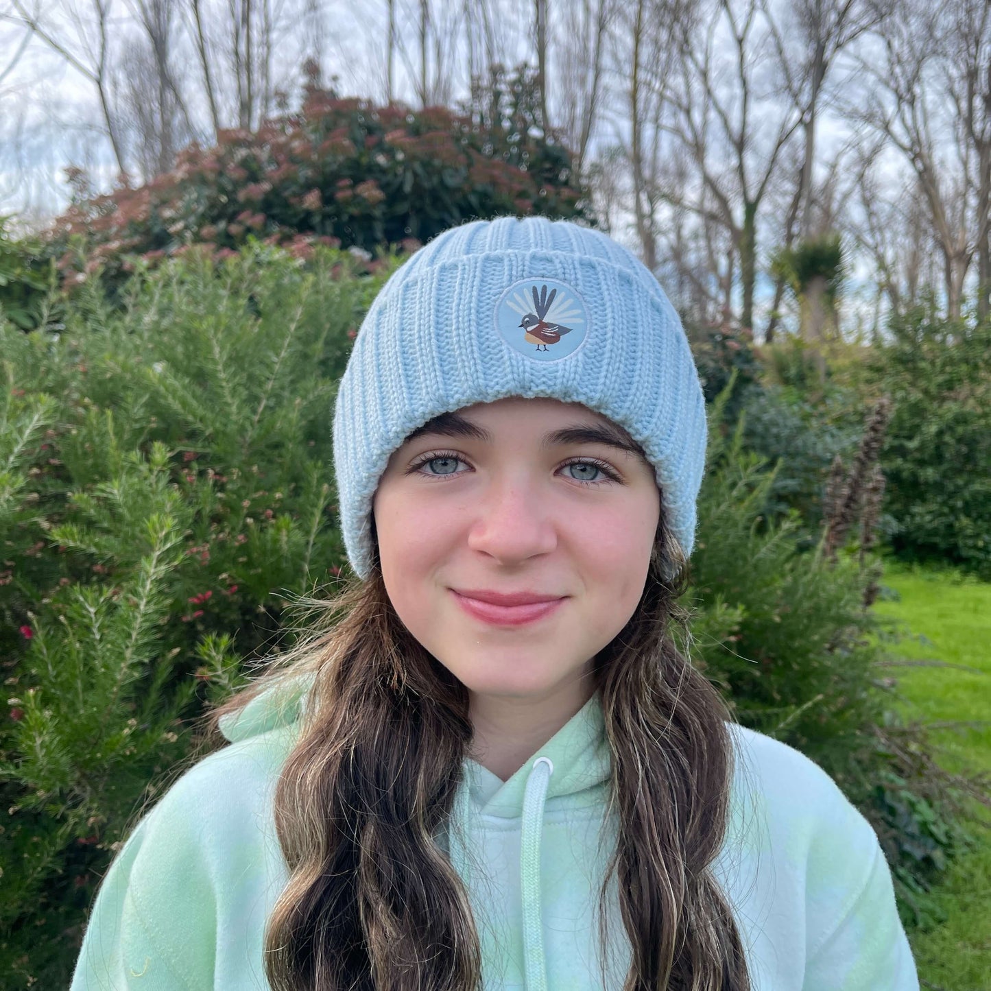 Kids blue knit beanie with fantail emblem on the front.