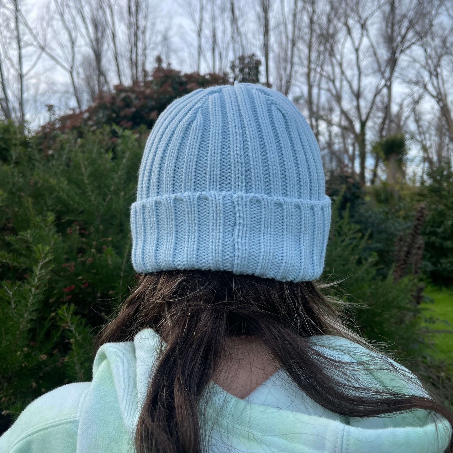 Back of child's head wearing light blue knit beanie.