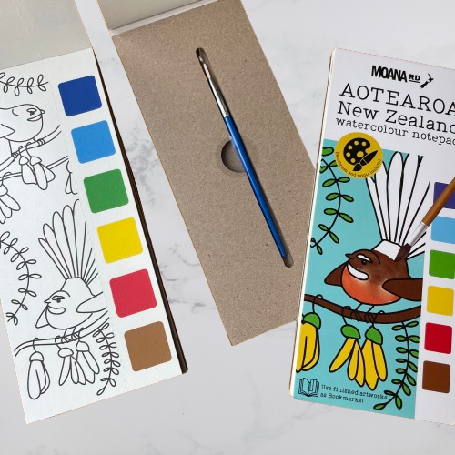Watercolour paint notepad with brush and paints on each page featuring Kiwiana outlines to colour in.