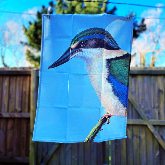 Pale blue tea towel with a Kingfisher bird on it.