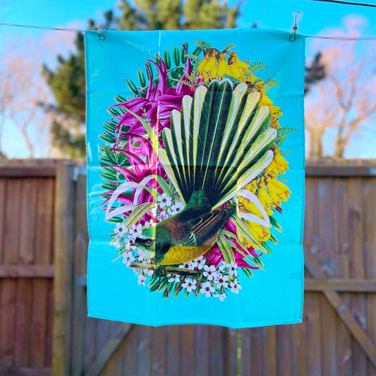 Tea towel with a Fantail and flowers on it.