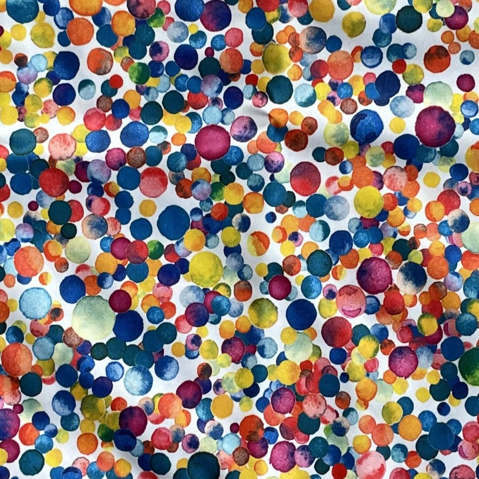 Close up of a multicoloured dotty fabric.