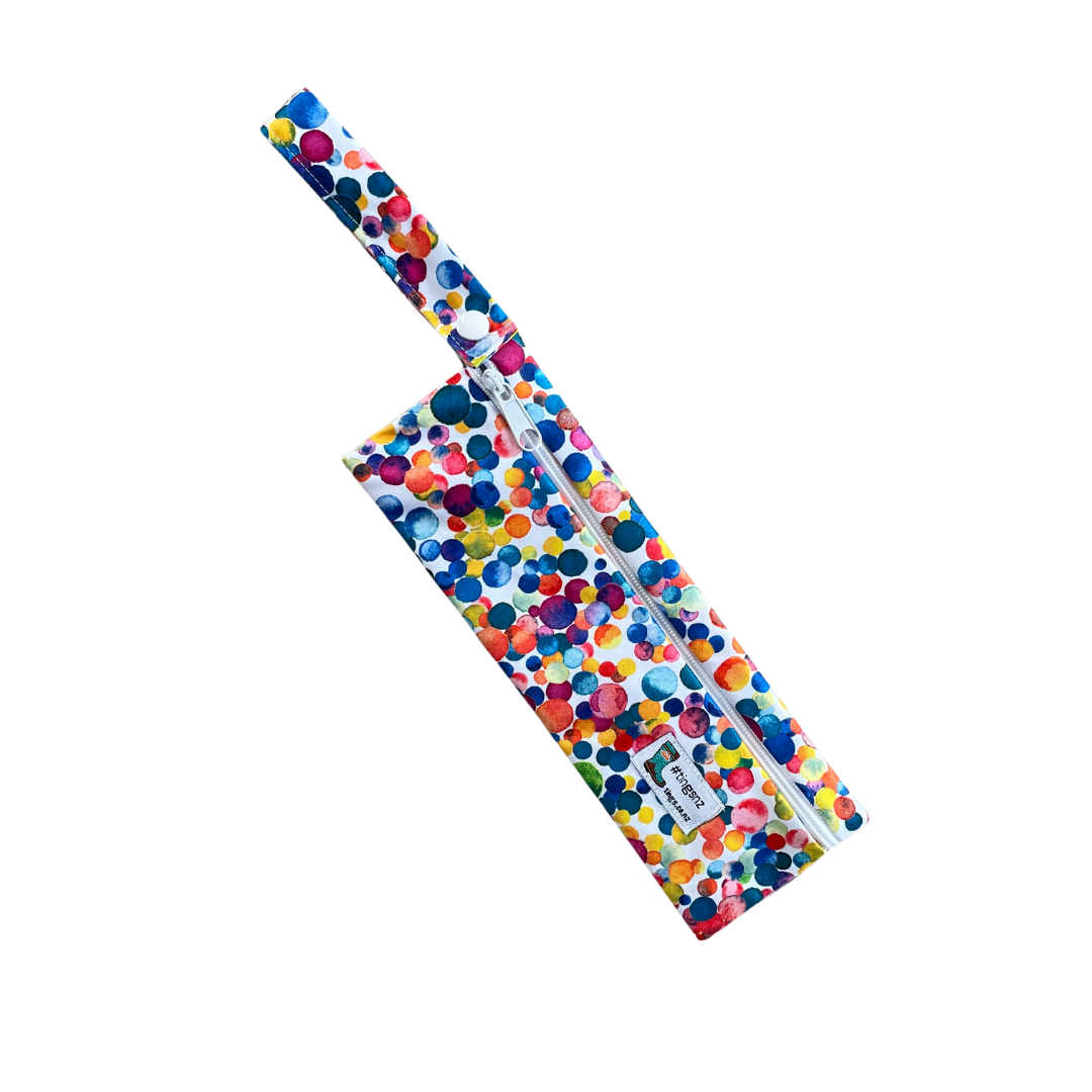 Small wetbag suitable for cutlery or toothbrushes in a multicoloured dotty print.
