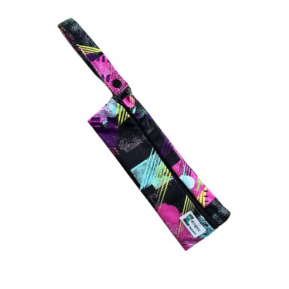 Small wetbag suitable for cutlery or toothbrushes in an abstract pink and black print.