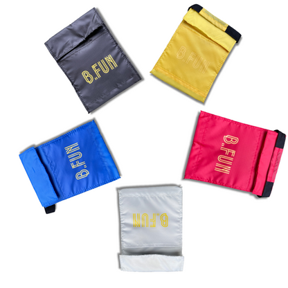 5 small lunch bags in black, yellow, red, white and blue iwth yellow text saying B.Fun printed on them, laid out in a circle on a white background.