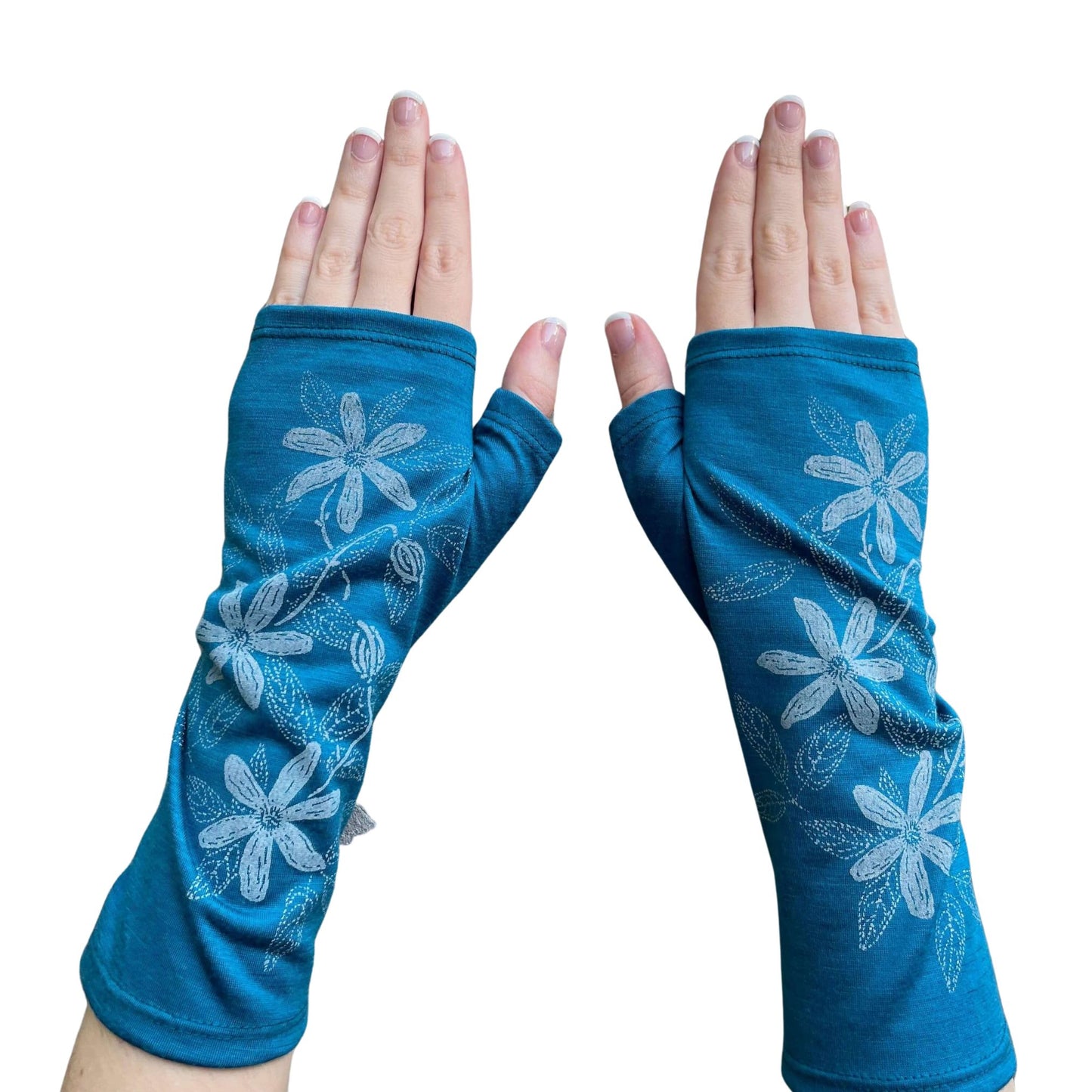 Fingerless merino gloves in teal with white clematis print.