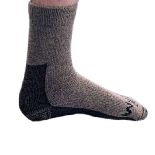 Mans foot in a brown woolen sock.