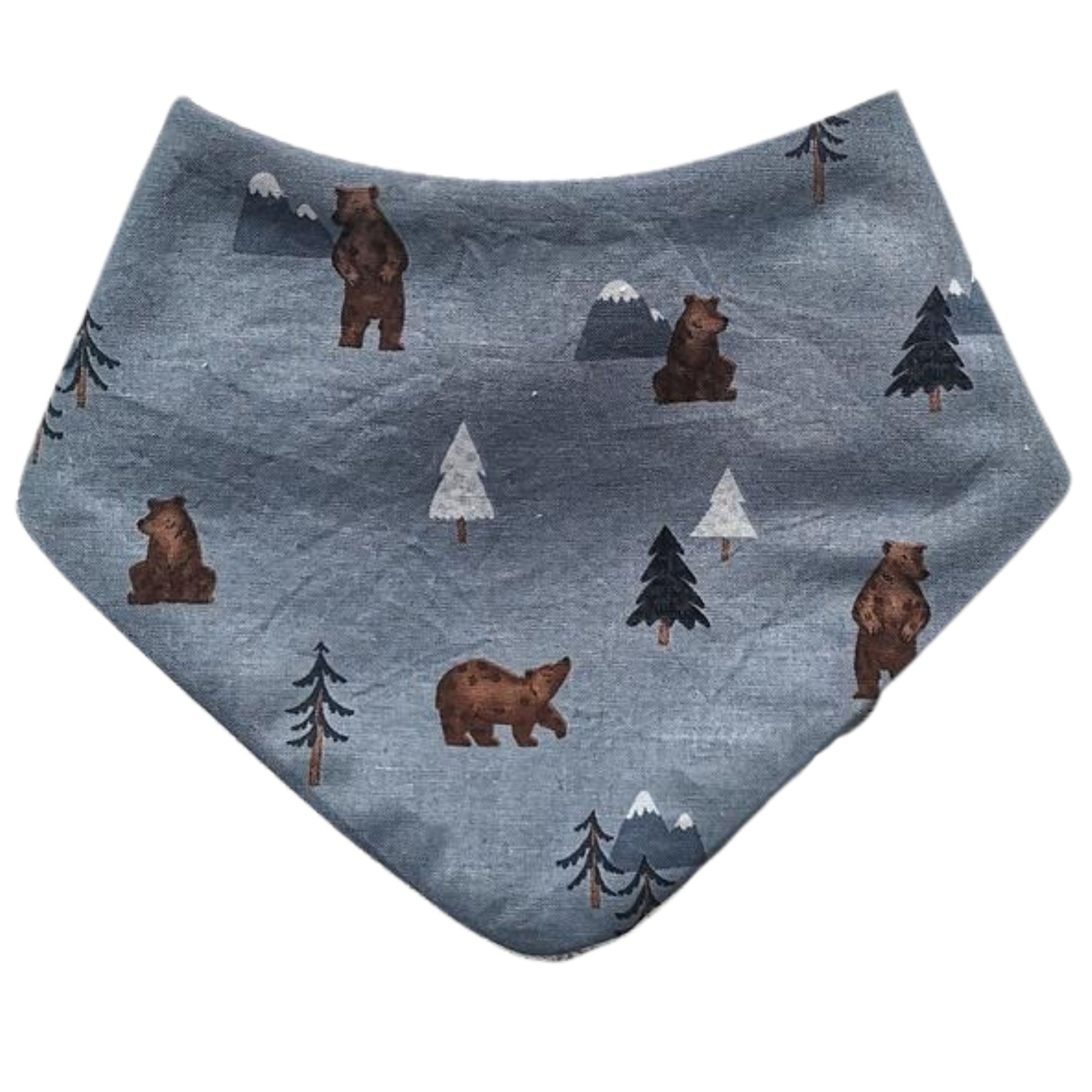 Baby dribble bib in dusky blue fabric with bears and pine trees printed on it.