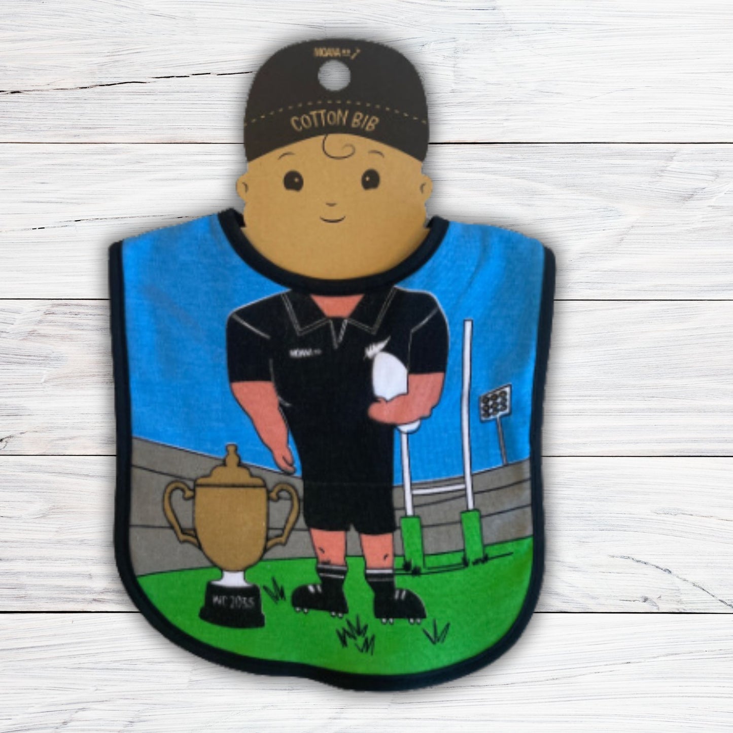 Baby bib featuring a rugby scene and body of a rugby player.