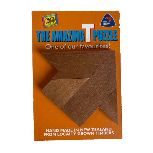 The amazing T puzzle made into an arrow shape sitting on orange backing card.