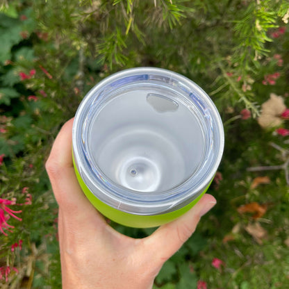  Birds eye view of a stainless coffee mug featuring the clear plastic sipper top.