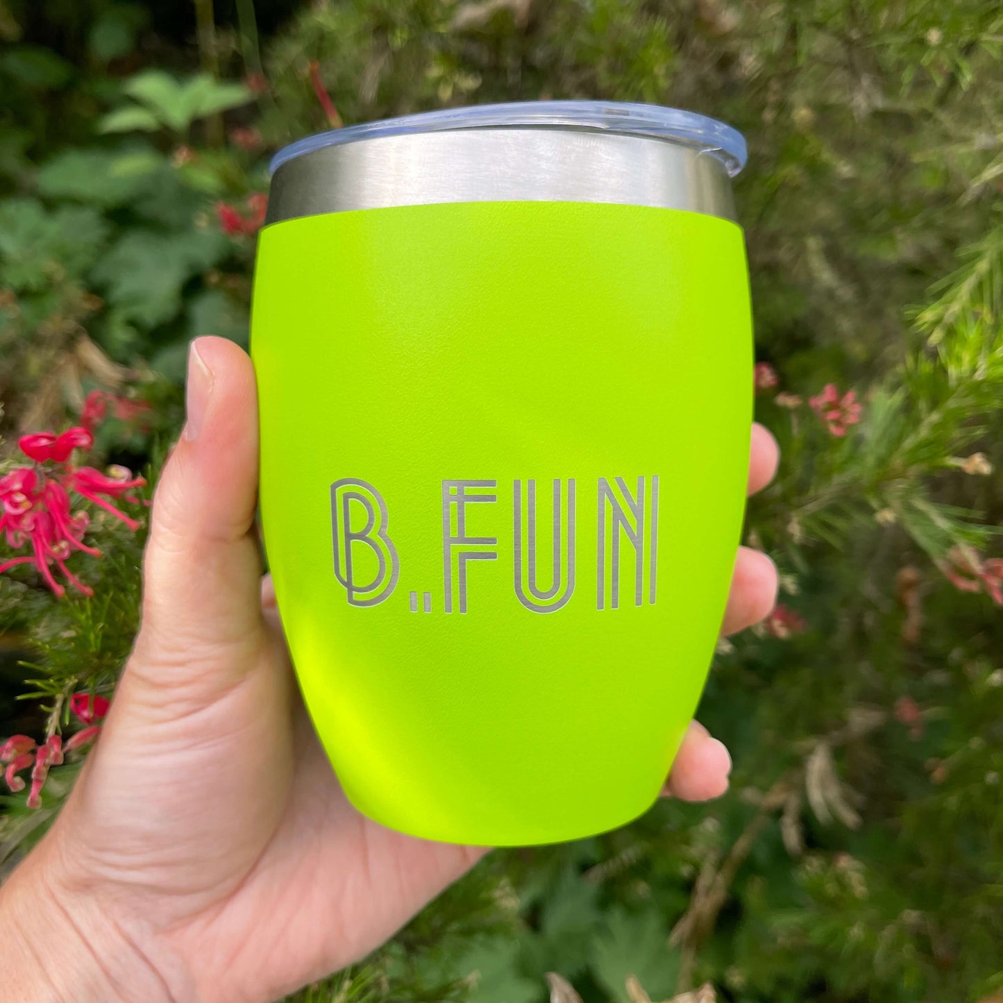 Lime green stainless coffee mug with B.FUN engraved into it.