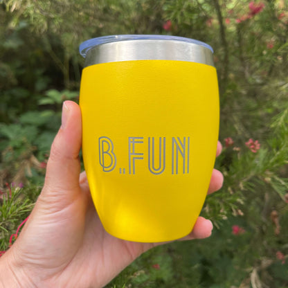 Bright yellow stainless coffee mug with B.FUN engraved into it.