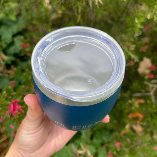 Birds eye view of a stainless coffee mug featuring the clear plastic sipper top.