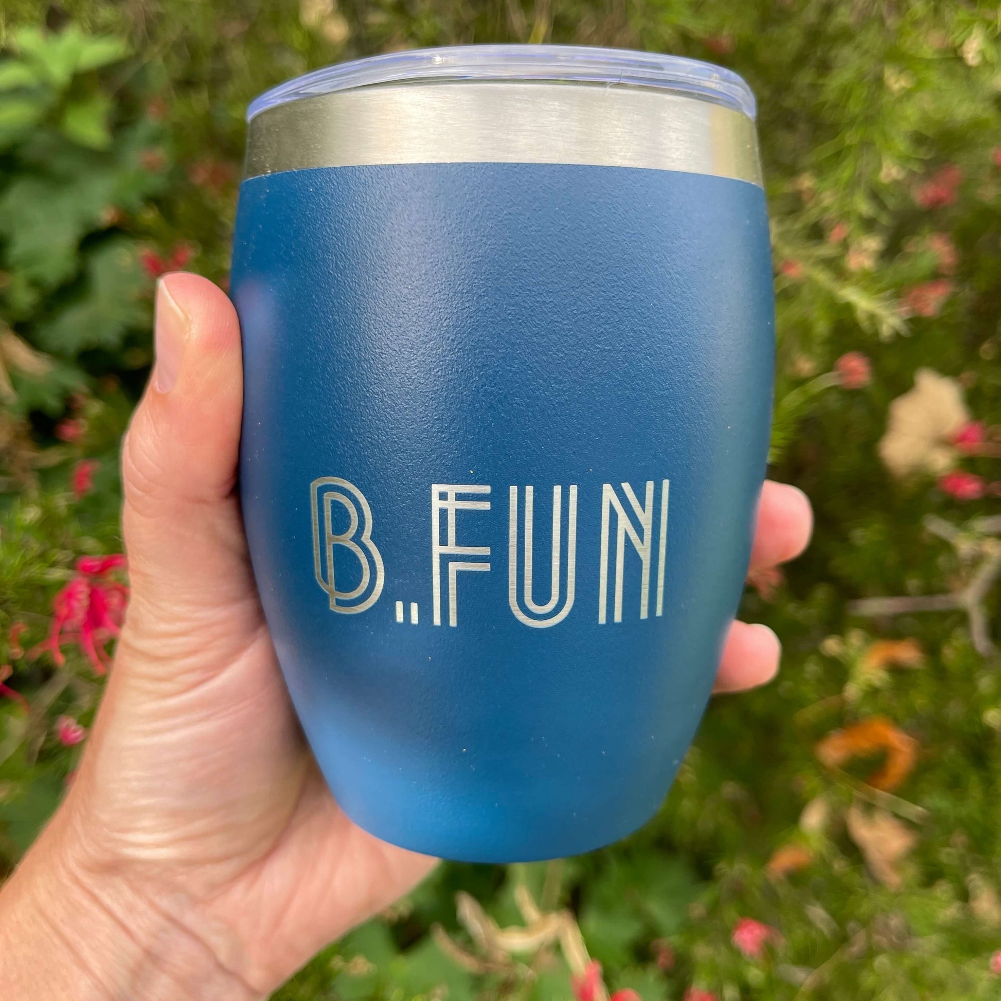 Navy blue stainless coffee mug with B.FUN engraved into it.