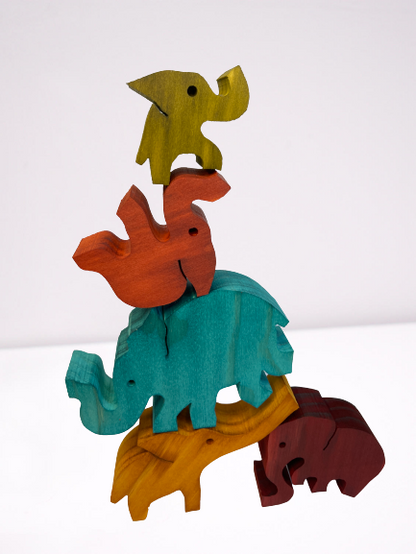 Wooden coloured balancing elephants.