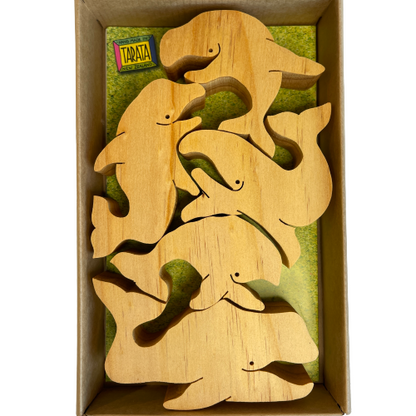 Box of natural wooden balancing whales.
