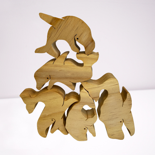 Natural wooden balancing whales.