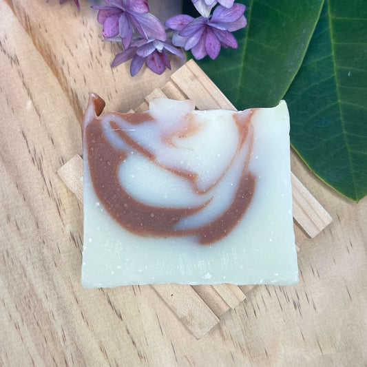 Natural soap bar on a wooden soap rack.