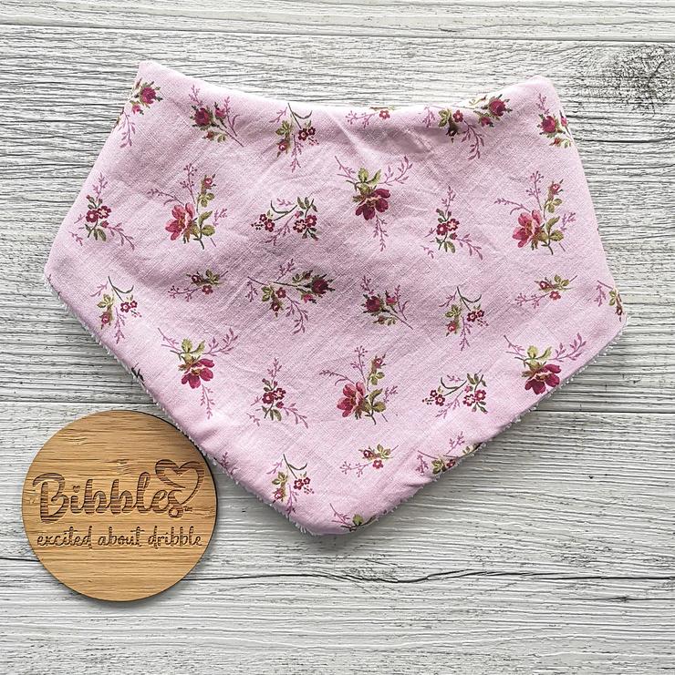Baby dribble bib in pink with maroon and pink floral print.